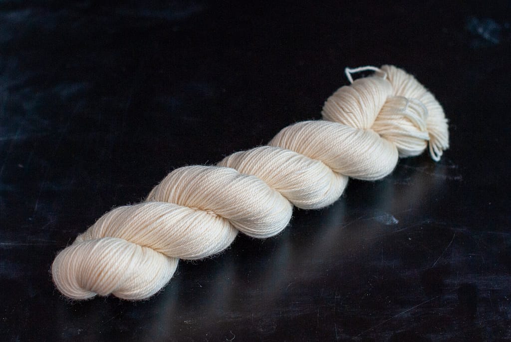A skein of undyed merino sport yarn 