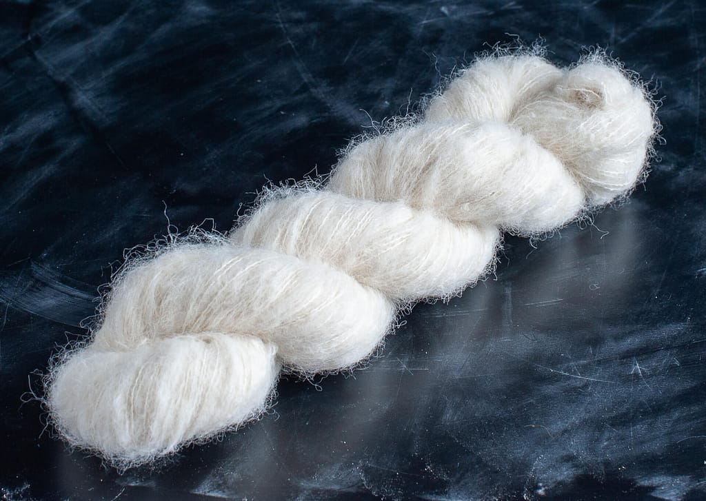 A skein of undyed suri alpaca lace yarn 