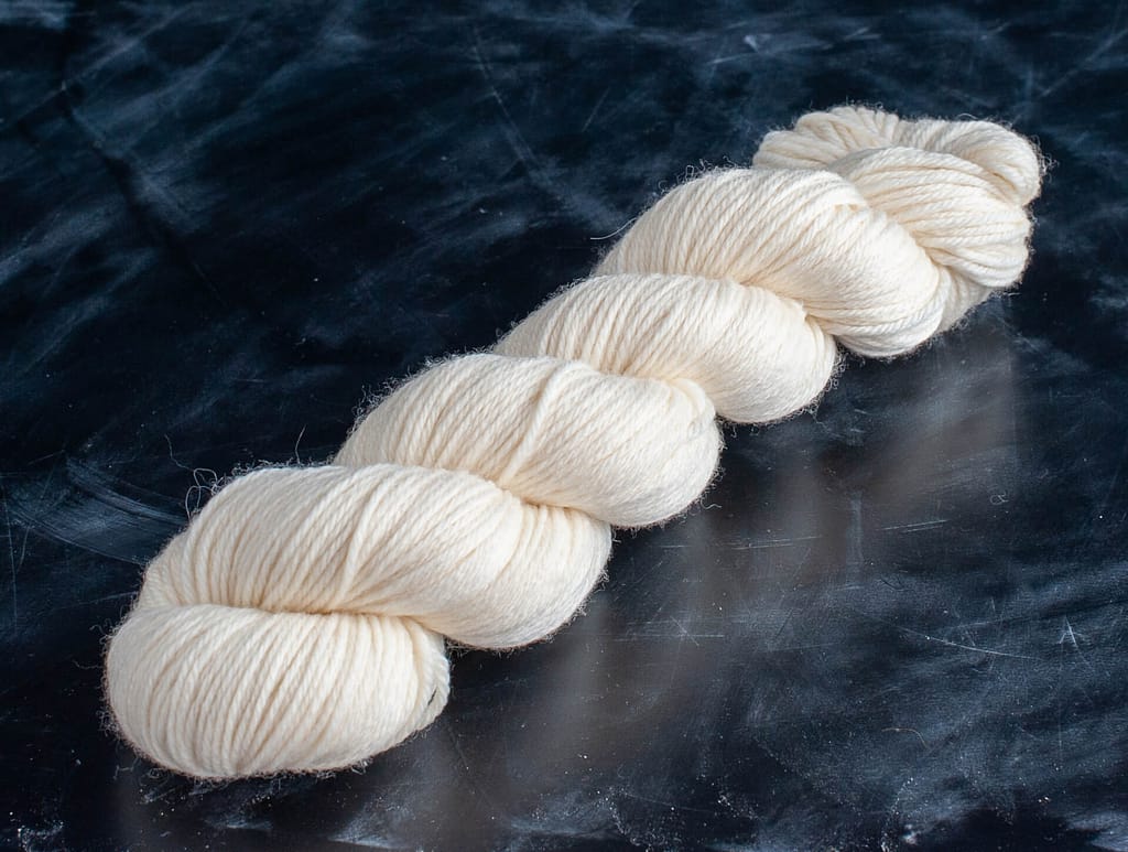 A skein of undyed merino dk yarn 