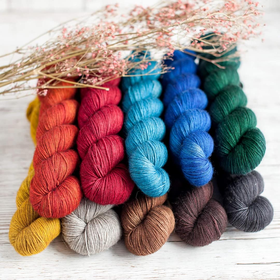 Ten skeins of yarn in different colors together