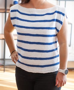 Woman wearing the Harbor Top in white with blue strips