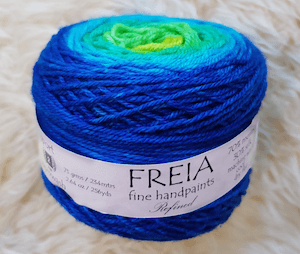 One skein of Freia yarn in a blue-green ombre.