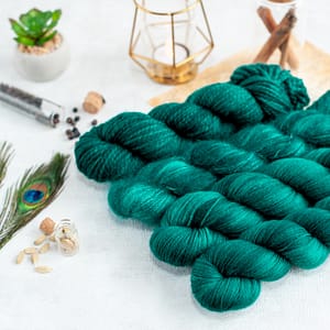 four skeins of teal green yarn