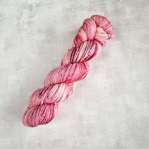 A speckled pink skein of merino yarn