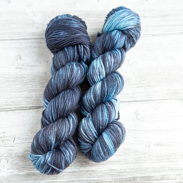 two skeins of yarn in the colorway 'Dark Storm'