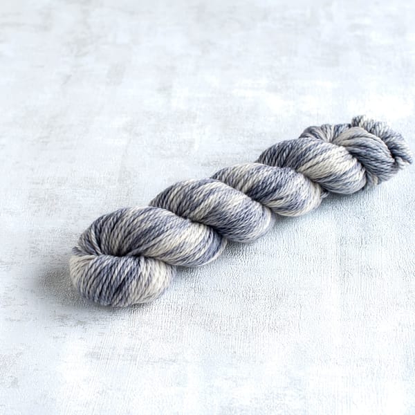 one skein of chunky weight light grey and white yarn