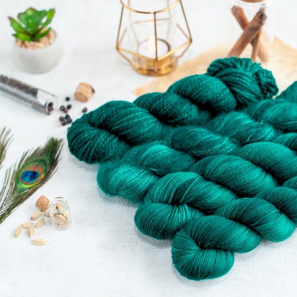 four skeins of teal green yarn