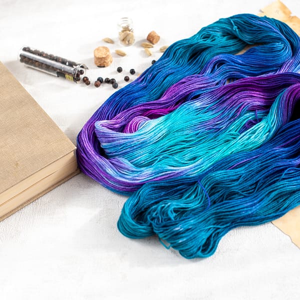 an open skein of blue, turquoise, green, and purple yarn