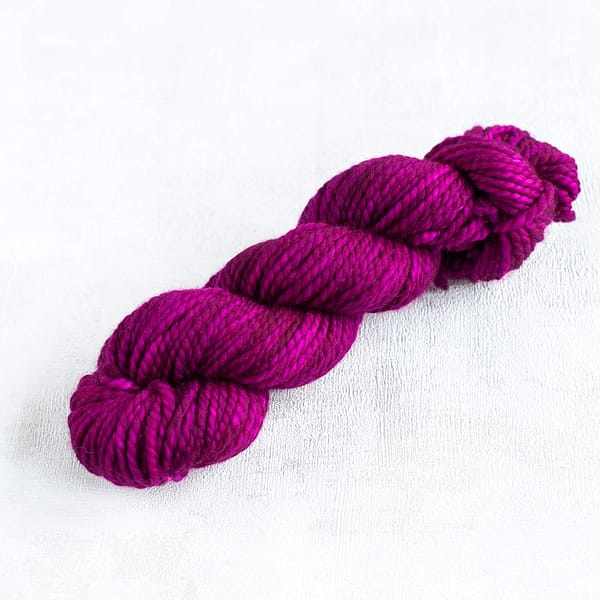 a skeins of chunky weight magenta yarn