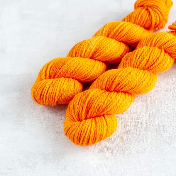 two skeins of chunky weight golden yellow yarn 