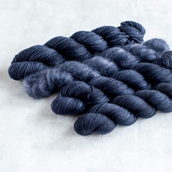 four skeins of blue-black yarn