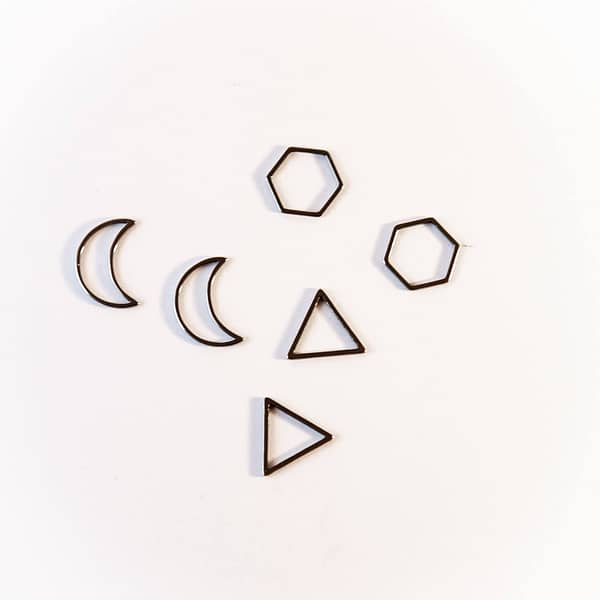two moon-, two honeycomb- and two triangle-shaped platinum stitch markers