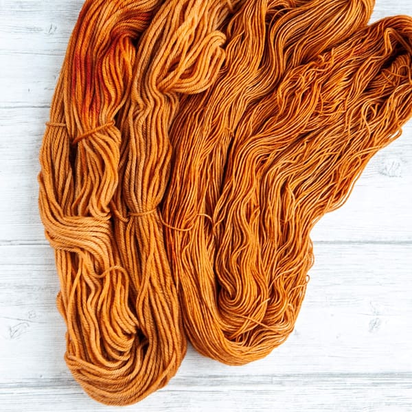 two skeins of yarn in the colorway 'Heilan Coo'