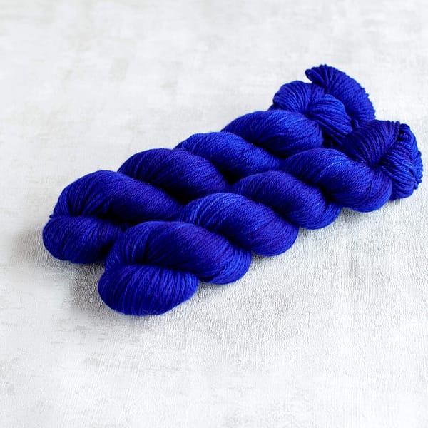 two skeins of DK weight midnight blue yarn