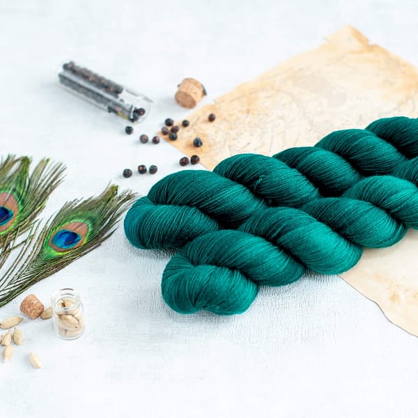 two skeins of fingering weight teal green yarn