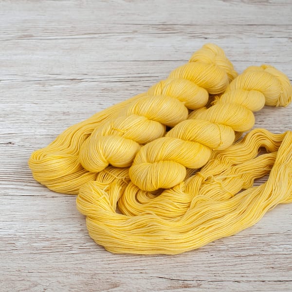 Two skeins of pastel yellow yarn