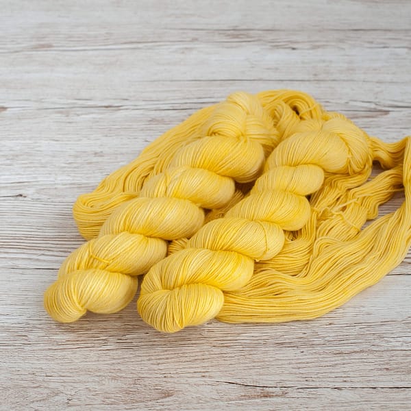 Two skeins of pastel yellow yarn