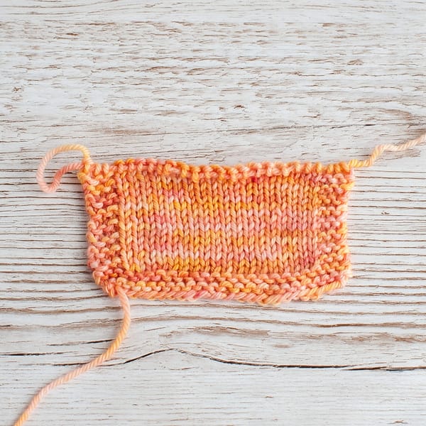 A knitted swatch of Peach Sorbet yarn
