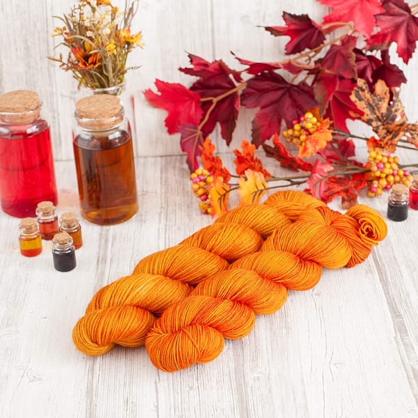 Two skein of orange yarn next to each other