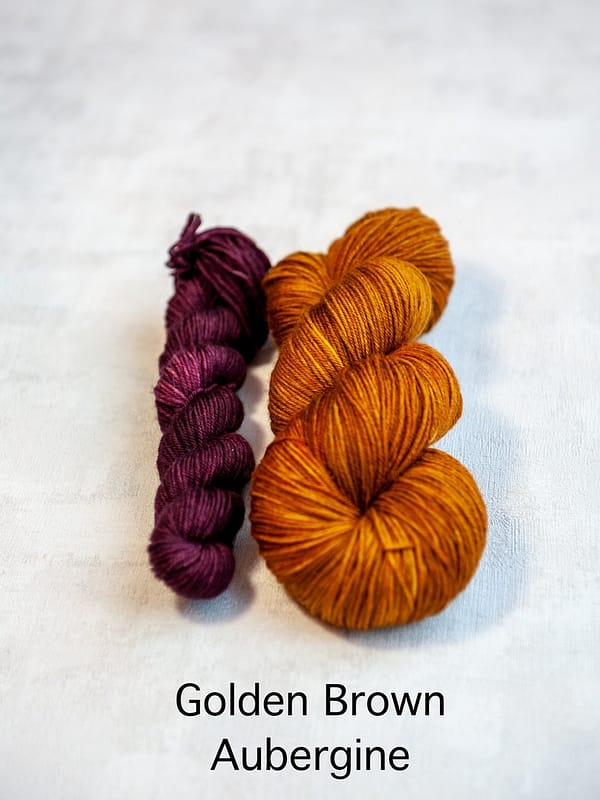 A sock set with the main skein in golden-brown and a mini skein in purple