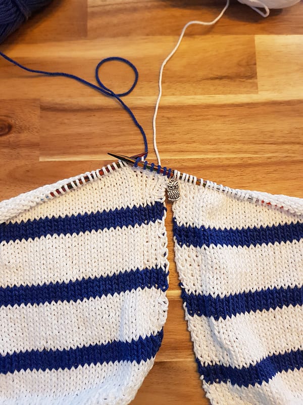 Two panels of the Harbor Top next to each other being knit together