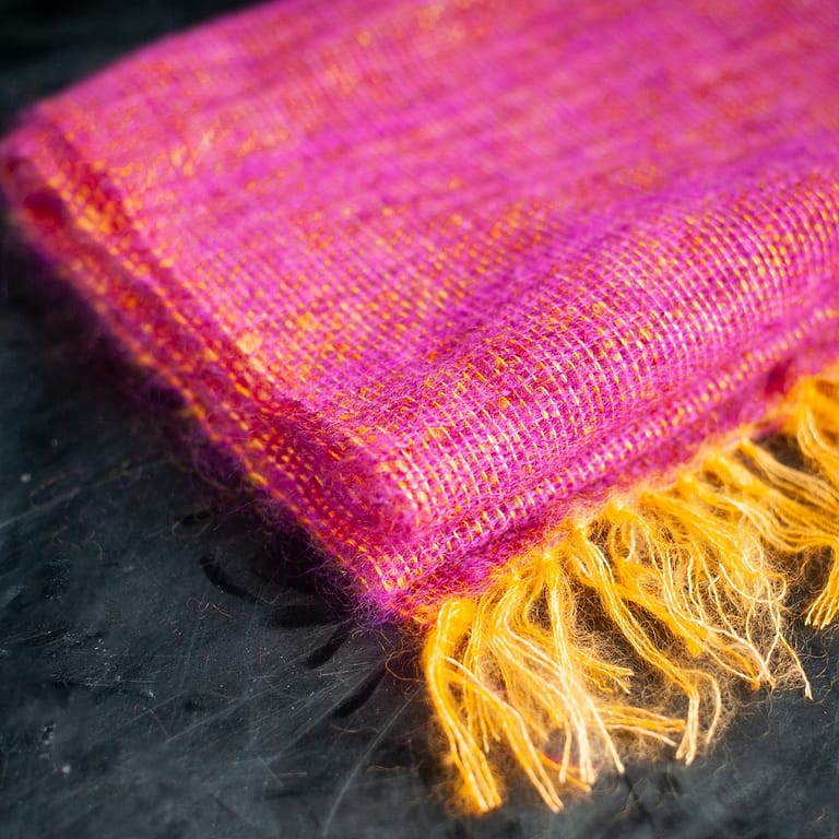 A woven mohair shawl folded and laid flat