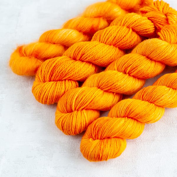four skein of golden yellow yarn