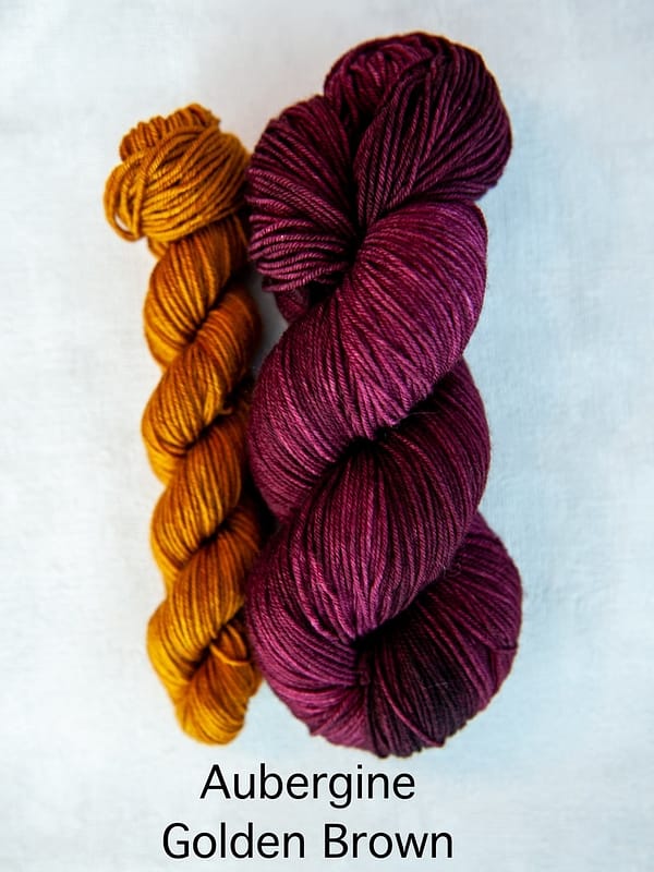 A sock set with the main skein in purple and a mini skein in golden-brown