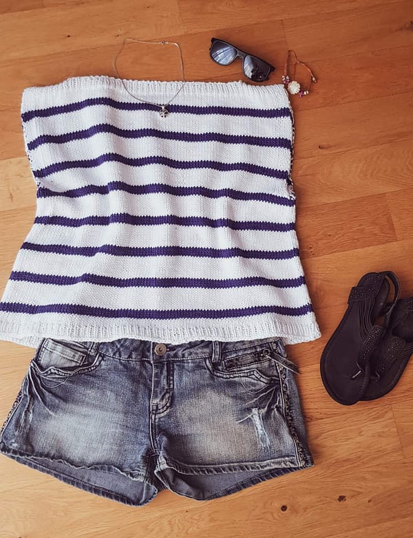 The knitted Harbor Top laid flat with a pair of jeans shorts and sandals