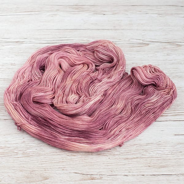 A skein of Vintage Rose yarn laid out flat