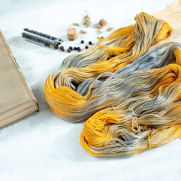 an opened skein of grey and yellow yarn