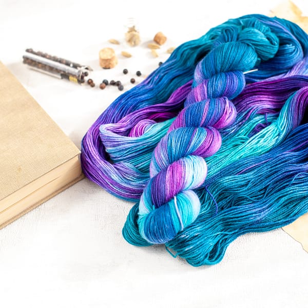 a skein of blue, turquoise, green, and purple yarn