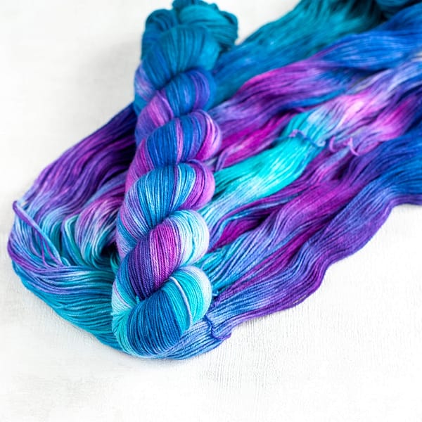 a skein of blue, turquoise, green, and purple yarn
