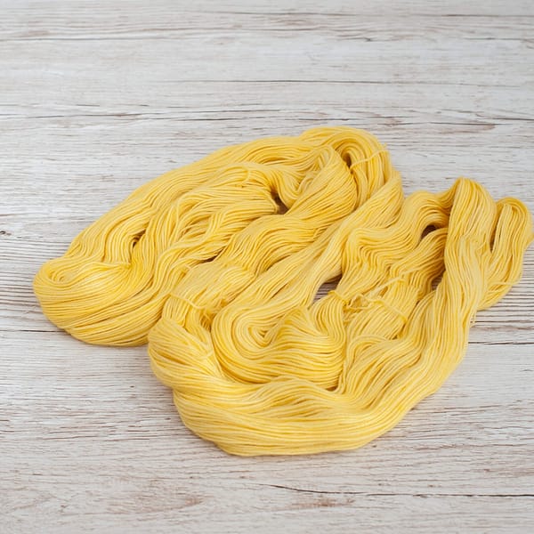 A pastel yellow skein of yarn 